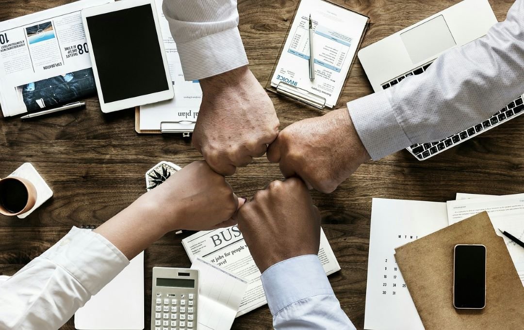 a group of people putting fists together